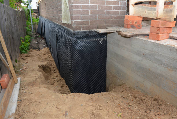 Happy homeowners after waterproofing job in Foley